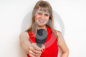Portrait of female reporter with black microphone