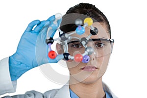 Portrait of female scientist holding molecular model