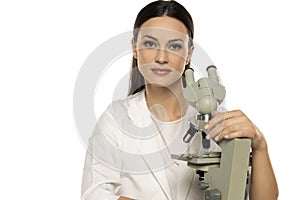 Portrait of female scientist with microscope