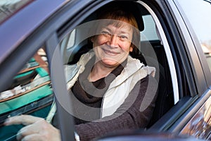 Portrait of female senior driver in car