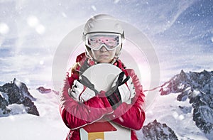 Portrait of a female snowboarder back against sunlight in mountains panorama