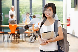 Portrait Of Female Student In Classroom With Digital Tablet