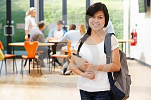 Portrait Of Female Student In Classroom With Digital Tablet