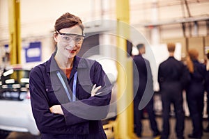 Portrait Of Female Student With Safety Glasses Studying For Auto Mechanic Apprenticeship At College