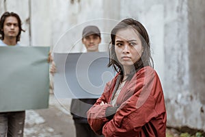 Portrait female students crossing their arms demonstrating with their friends