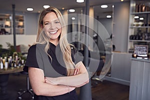 Portrait Of Female Stylist Or Business Owner In Hairdressing Salon