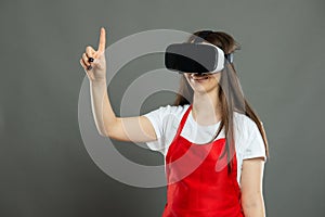 Portrait of female supermarket employee gesturing waring vr goggles