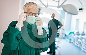 Portrait of female surgeon wearing surgical mask in the operating room