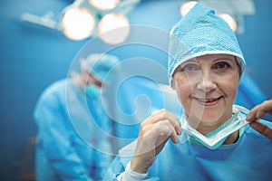 Portrait of female surgeon wearing surgical mask in operation theater