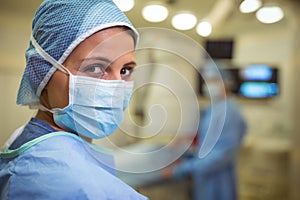 Portrait of female surgeon wearing surgical mask in operation theater