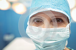 Portrait of female surgeon wearing surgical mask in operation theater