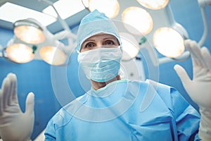 Portrait of female surgeon wearing surgical mask in operation theater