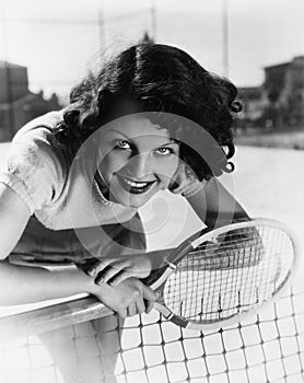 Portrait of female tennis player at the net