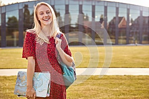 Portrait Of Female University Or College Student Standing Outdoors By Modern Campus Building