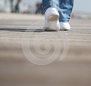 Portrait of a female walking in comfortable white shoes