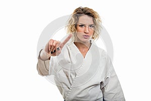 Portrait of female wearing martial arts uniform making denial gesture