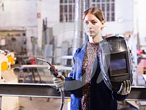 Portrait of female welder in factory workshop