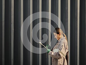 Portrait of a female worker holding clipboard