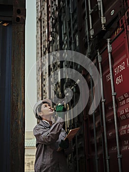 Portrait of a female worker holding clipboard