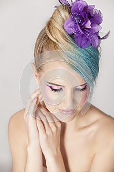 Portrait of feminine woman with blonde and blue ombre hair and purple makeup