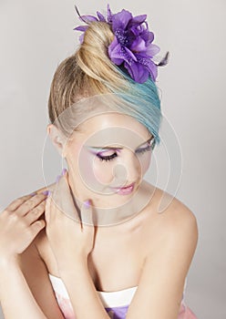 Portrait of feminine woman with blonde and blue ombre hair and purple makeup