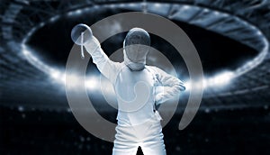 Portrait of a fencer against the backdrop of a sports arena. The concept of fencing
