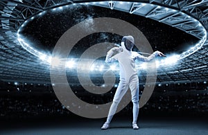 Portrait of a fencer against the backdrop of a sports arena. The concept of fencing