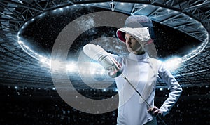 Portrait of a fencer against the backdrop of a sports arena. The concept of fencing