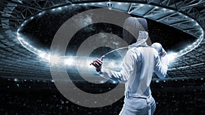 Portrait of a fencer against the backdrop of a sports arena. The concept of fencing. Back view
