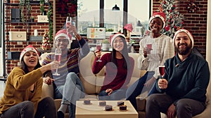 Portrait of festive coworkers clinking glasses with alcohol