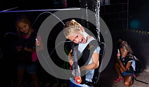 Portrait of fine tweenager boy with laser gun