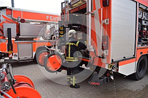 portrait of a firefighter at the emergency vehicle in the fire station