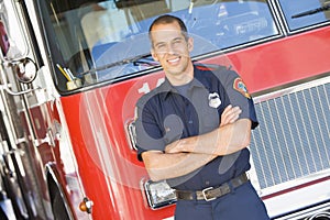 Portrait of a firefighter by a fire engine