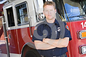 Portrait of a firefighter by a fire engine