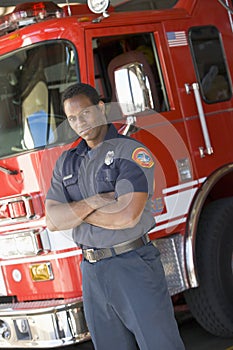 Portrait of a firefighter by a fire engine