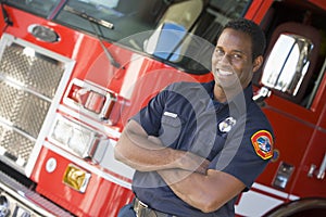 Portrait of a firefighter by a fire engine