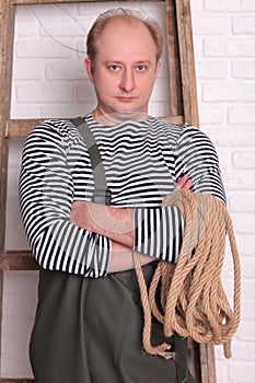 Portrait of a fisherman in waders with rope