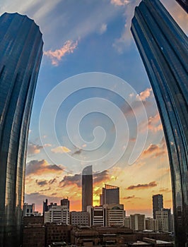 Portrait fisheye lens shot of World Trade Center, Sheikh Mohammed Bin Rashid Tower against a cloudy sunset in Abu Dhabi city