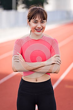Portrait of a fit and frim young woman wears sport clothes ready to workout in the city stadium in the morning. Healthy and