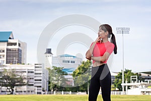 Portrait of a fit and frim young woman wears sport clothes ready to workout in the city stadium in the morning. Healthy and