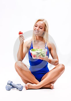 Portrait of a fit healthy woman eating a fresh salad