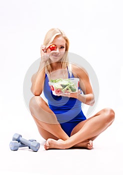 Portrait of a fit healthy woman eating a fresh salad