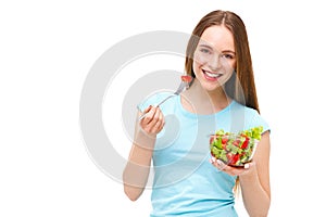 Portrait of a fit healthy woman eating a fresh salad isolated