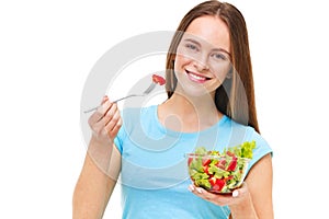 Portrait of a fit healthy woman eating a fresh salad isolated