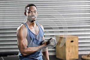 Portrait of fit man lifting dumbbells