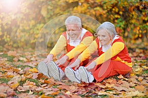 Portrait of fit senior couple exercising in autumn park