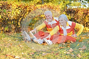 Portrait of fit senior couple exercising in autumn park