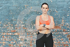 Portrait, fit and woman in arms crossed, smart watch and sportswear for wellness, exercise or health. Female athlete