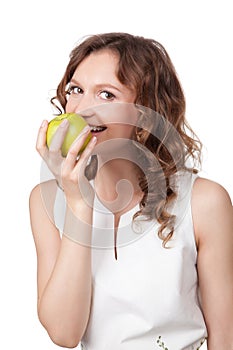 Portrait of fit young girl biting a fresh ripe apple