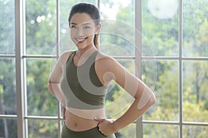 Portrait of fit young woman wearing sportswear at home, sport and healthy lifestyle concept